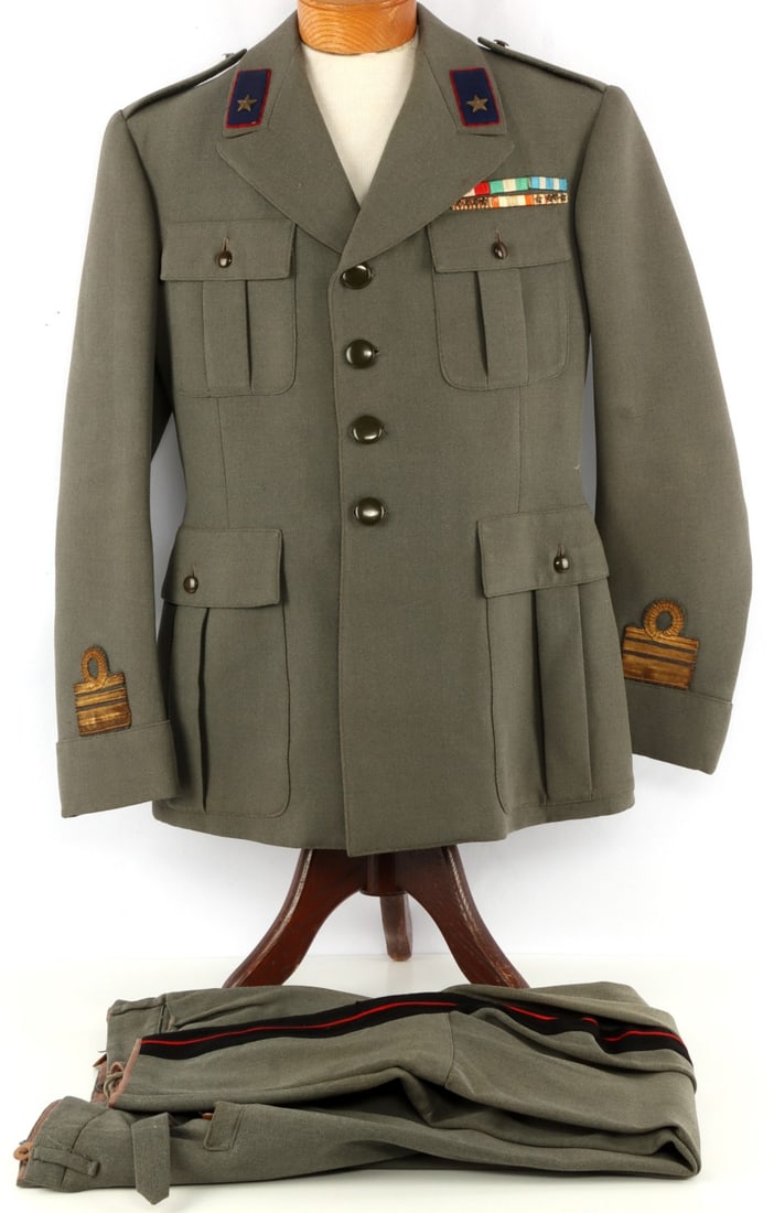 WWII FASCIST ITALY MILITARY COLONELS DRESS UNIFORM: Uniform for a colonel in the military of the fascist Kingdom of Italy. Gray fabric, red and blue collar tabs, black and red ribbons along the inseam of the pants, and intact ribbon bars. Collar tab st