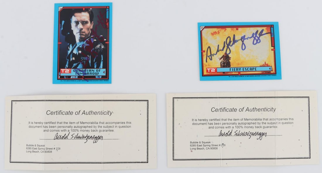 LOT OF 2 ARNOLD SCHWARZENEGGER SIGNED CARDS: Lot of two (2) TERMINATOR-themed trading cards signed by Arnold Schwarzenegger. Includes two (2) certificates of authenticity from Bubble & Squeak (Long Beach, CA). Very good, original condition.