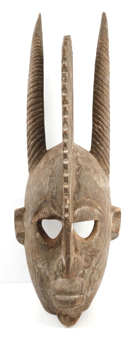 LARGE 2.5 FOOT AFRICAN CONGO WOODEN MASK: Large African mask, consistent with some examples found in the Congo. Mask depicts a horned, finned figure, with hollowed out neck and back of head portion and geometric patterns. Staining along mouth