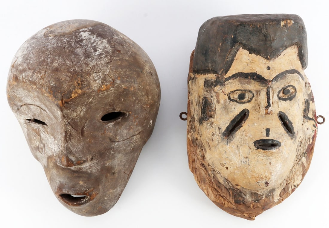 LOT OF 2 WOODEN AFRICAN MASKS CONGO NORTH AFRICA: Lot of TWO (2). 1) Wooden mask with white and black paint. The figure depicted is male, with scarification motif on cheeks. Likely North African. 9.5 X 7 X 13 inches. 2) Wooden mask depicting an asymm