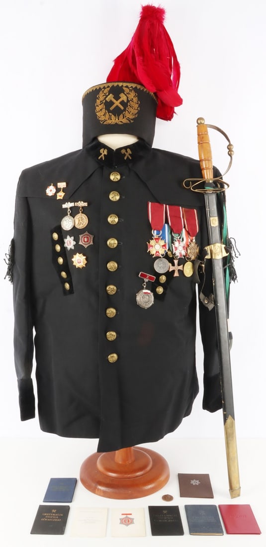 COLD WAR POLISH MINER PARADE GALA UNIFORM & SWORD: Cold War-era Polish Miner's parade uniform's tunic, gala hat, and parade sword. Gala hat features a red feather. Tunic features collar tabs and various medals including Polish Merit Crosses (bronze, s