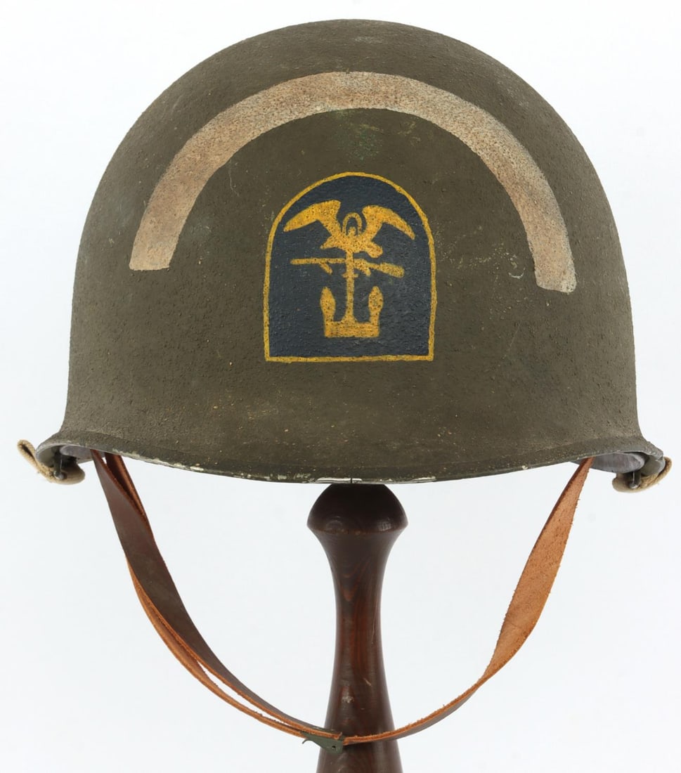 WWII US M1 HELMET & LINER 1ST ENGINEER BRIGADE: Front seam M1 helmet with painted insignia of the 1st Engineer Brigade. No apparent maker's mark. Includes shell and liner. Very good condition.