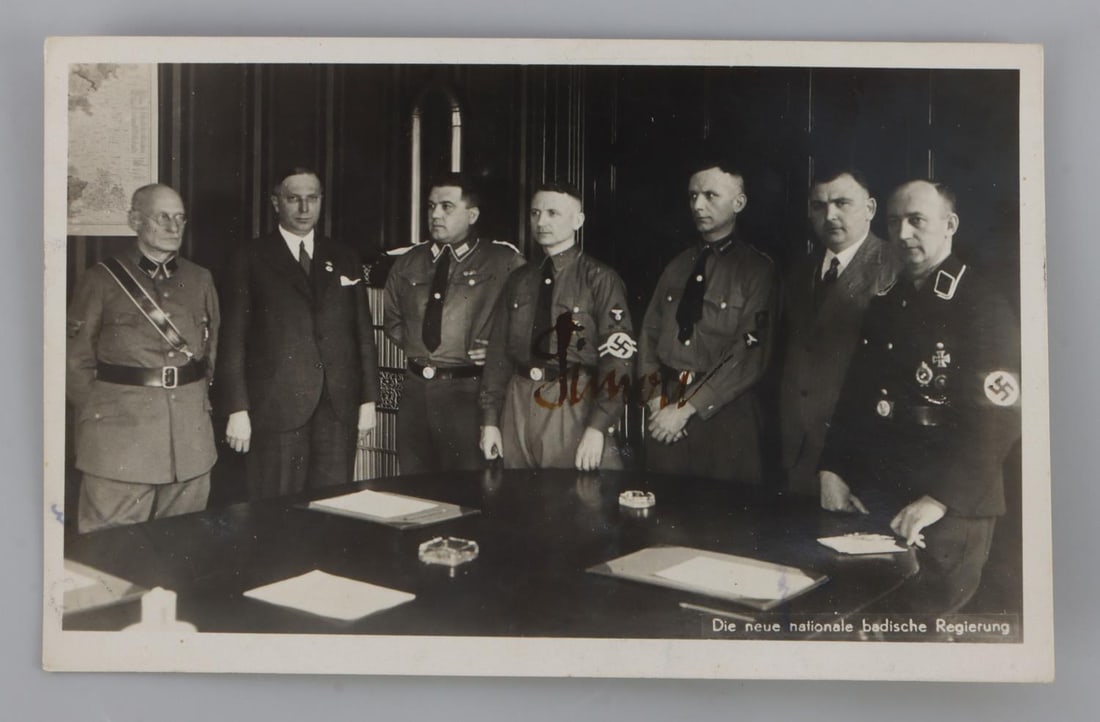 WWII GERMAN THIRD REICH GUSTAV SIMON AUTOGRAPH: Postcard depicting several senior members of the NSPAD. The item is signed 'SImon' over the image of Gustav Simon, the Gauleiter of Gau Moselland and administrator of occupied Luxembourg. Signature ma