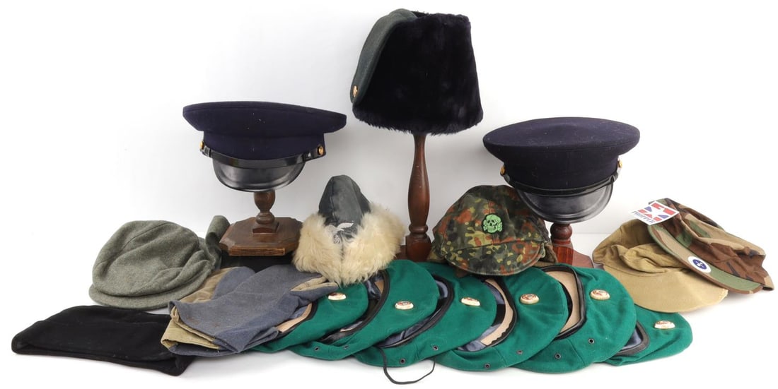 LOT OF WWII GERMAN AND RUSSIAN CAPS VTG AND MODERN: 17-piece lot of assorted headwear. Includes flecktarn totenkopf cap, Propper International camo cap, Russian berets, cossack, a pair of winter gloves, and more. Some appear original, some are marked, 