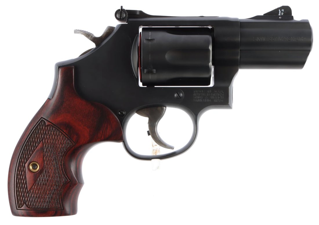 PERFORMANCE CENTER M19 .357 CARRY COMP REVOLVER: K-frame series carbon steel frame with 2.5-inch stainless steel barrel. 6-round cylinder. Shrouded ejector rod. Fixed front blade sight. Adjustable rear sight. Checkered rosewood grips with replacemen