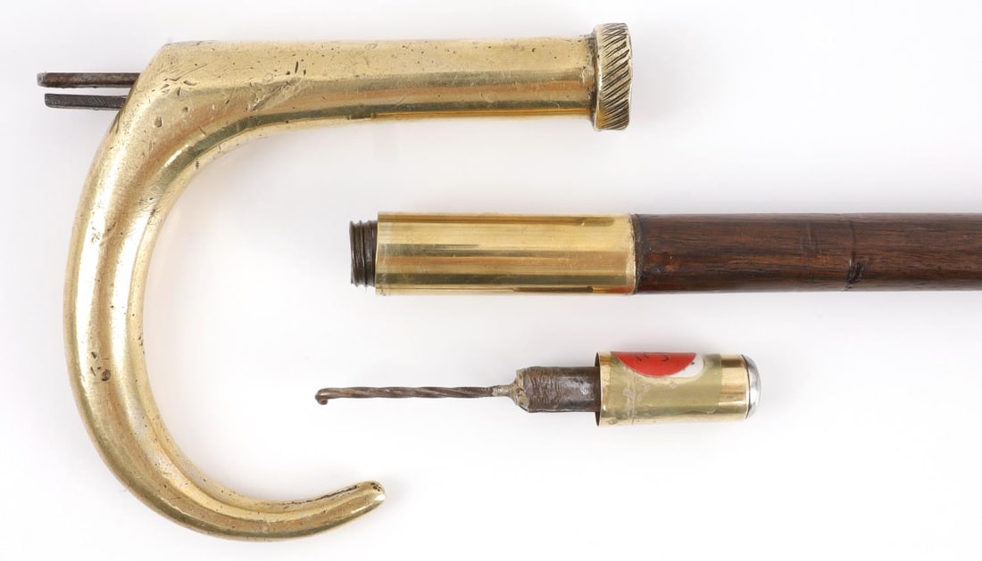 ANTIQUE GENTLEMAN GUN CANE WALKING STICK: Brass handle with steel barrel in wood shaft. 32 inches. Clear bore. Ferrule tip is removed and serves as tool to retract hammer. Breach measures 9.3mm. Tip measures 8.4mm. Functions without issue. Ca