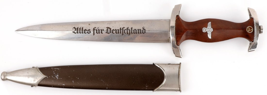 WWII GERMAN THIRD REICH SA HONOR DAGGER M7/55: Steel blade with etched motto and RZM mark. Tang does not feature filing. Nickel crossguards. Wood grip with inlaid eagle and SA runes. Marked RZM M7/55 1942. 14 5/8 inches. Very good condition.