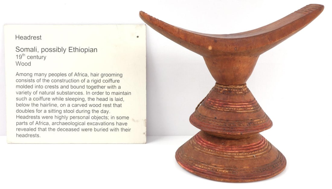 AFRICAN SOMALI BONI WOODEN HEADREST: African Somali headrest for sleeping and hairdressing, developed by the Boni people. Wood with red, yellow, and green paint on base, though faded. 7 X 5 inches. Very good condition.