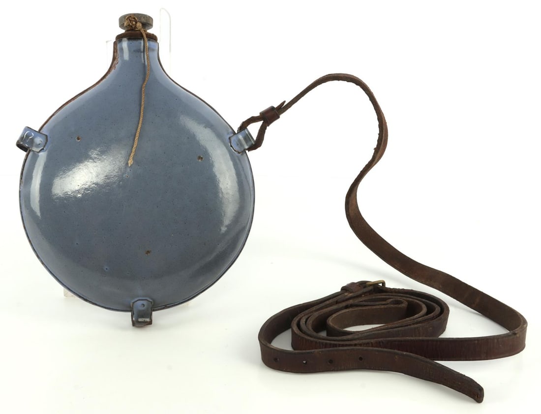BRITISH BOER WAR 1895 MODEL SERVICE CANTEEN: Blue enameled. Magnetic. Includes leather strap. Canteen measures approx. 9.5 (T) X 7 (W) inches. Very good condition.
