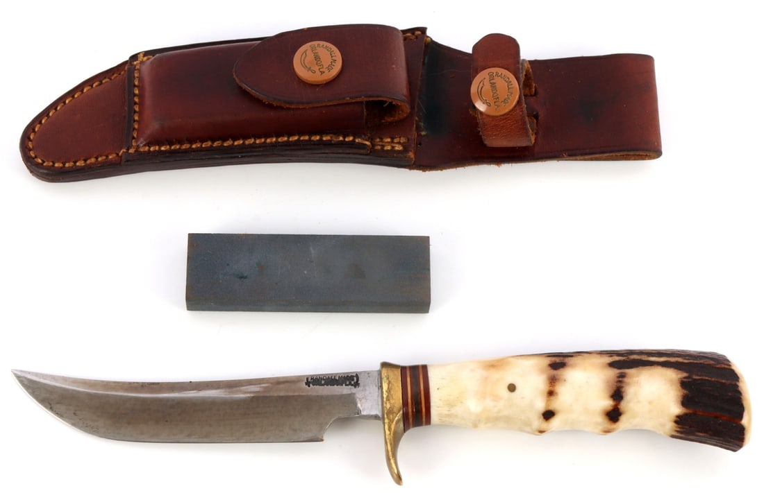 RANDALL KNIFE WITH HEISER SHEATH MODEL 7: Corn row rough back H.H. Heiser factory sheath. 7-inch blade engraved with "Dr. G.I. Fielding". 12 inches overall. Stag grip Randall buttons on sheath. Very good, original condition. This lot has a re