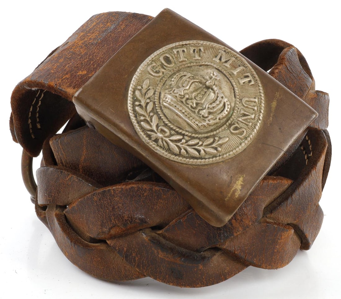 WWI GERMAN GOTT MIT UNS BUCKLE & BRAIDED BELT: 1) Got Mitt Uns brass belt buckle from Imperial Germany in WWI. Bent on the dome. 2.5 X 1.9 inches. Very good original condition. 2) 33-inch braided belt. Of unknown origin.