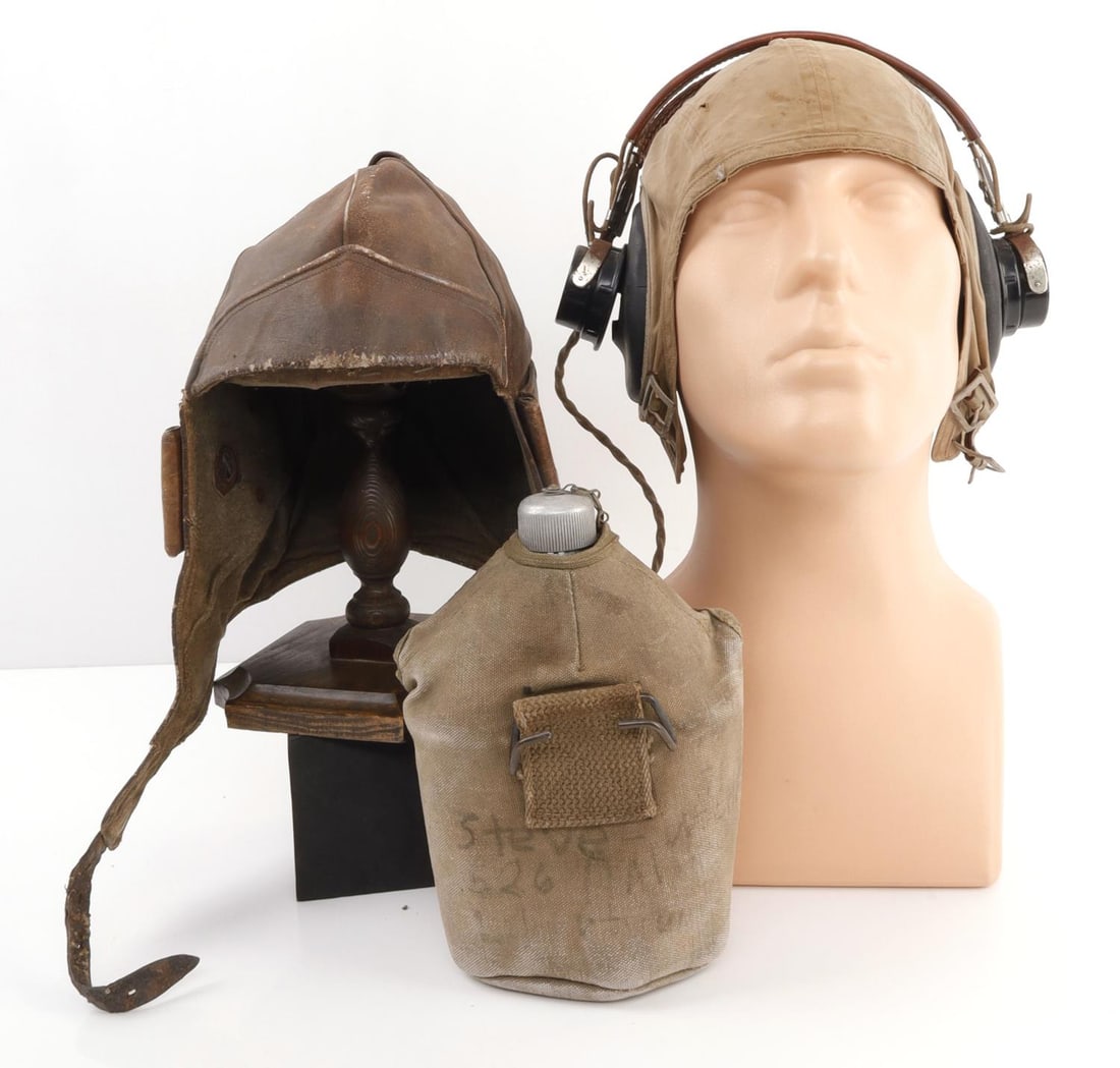 LOT OF 2 US MILITARIA CANTEEN & PILOT FLIGHT CAPS: Lot of TWO (2). 1) P-38 canteen with cloth wrap. Cloth wrap is stamped 'U.S.' 7 X 6 inches. Name written on back in faded marker, first name is 'Steve.' Last name is partially illegible, but could be 