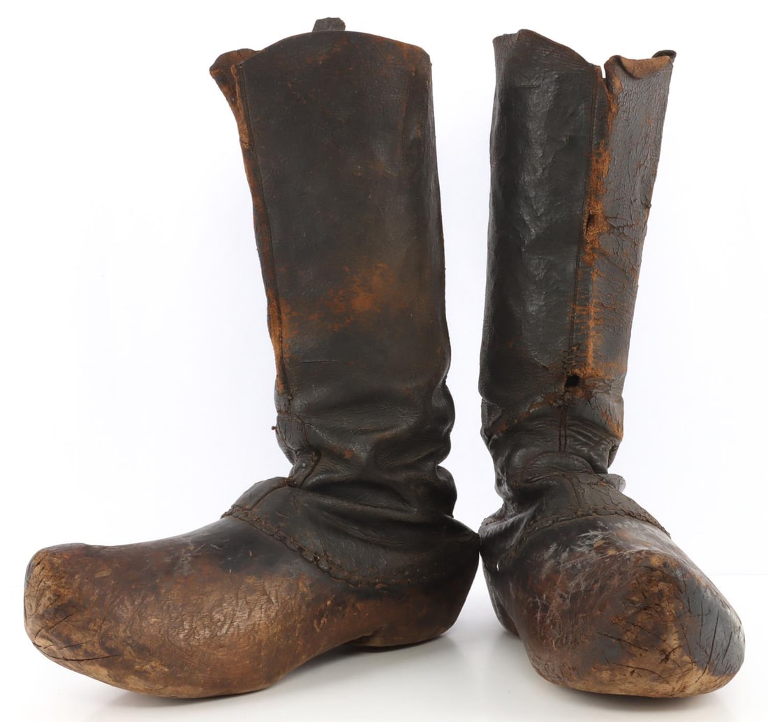 PAIR OF WWII GERMAN REICH HOLOCAUST WORKBOOTS: Pair of wooden work shoes from the Madjenek camp. 13 (L) X 15 (T) inches. Hand stitched and carved. Very good, original condition.