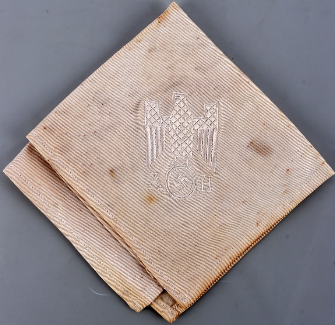 WWII GERMAN THIRD REICH ADOLF HITLER NAPKIN: Napkin showing the Fuhrer's Reichsadler and the letters 'AH.' Resembles some known historical examples. Fluoresces. 12 X 11.5 inches. Unauthenticated, sold "as is."