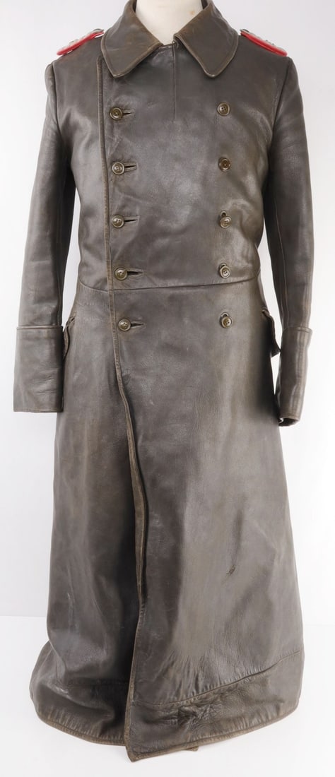 WWII GERMAN WEHRMACHT LEATHER COAT FOR OFFICERS: Typical construction with a horizontal leather belt to the reverse showing two buttons. Two vertical button lines to the front. Loops and buttons for shoulder boards. Soft leather. All buttons complet