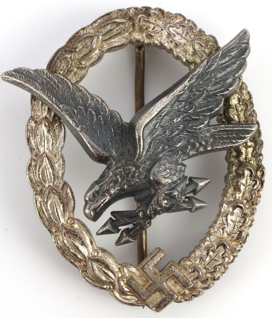 WWII GERMAN LUFTWAFFE RADIO OPERATOR BADGE B & NL: Third Reich Luftwaffe Radio Operator & Air Gunner award badge. Solid-struck two-piece construction, non-magnetic alloy. Reverse has two domed rivets and thin vertical wire pin. Reverse of eagle marked