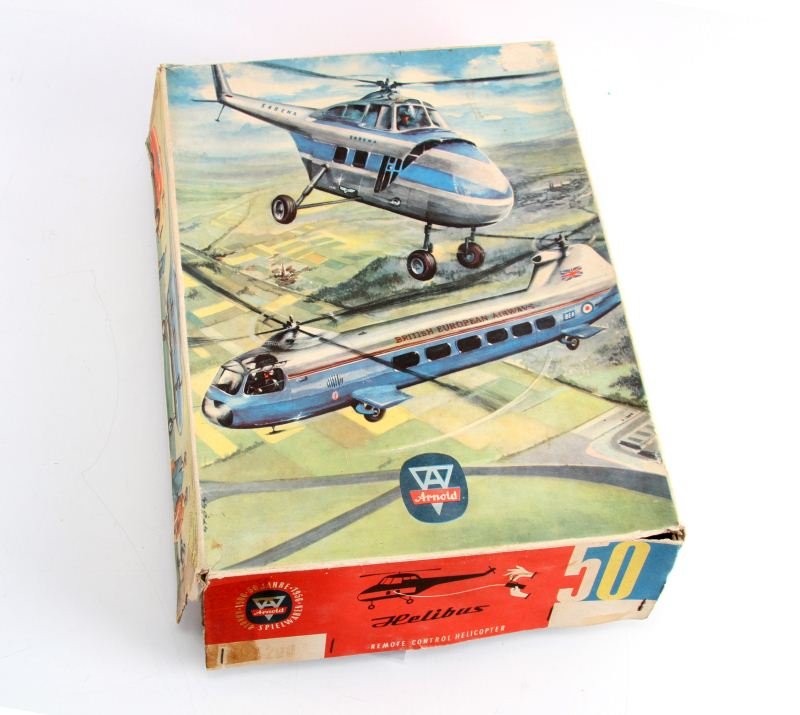 HAND POWERED METAL FLYING HELICOPTER MODEL: Arnold of West Germany Helibus Helicopter, is a tin hand-powered remote control model. In original boy overall in excellent condition.