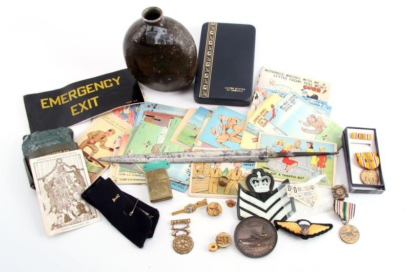 MILITARIA COLLECTIBLE LOT DAGGER MEDALS ZIPPO MORE: SMF Nazi dagger blade, WWII Japanese canteen without stopper, early Zippo lighter in good condition with U.S. Seal embossed, empty U.S. medal box, over 50 WWII humor postcards (very good unused condit
