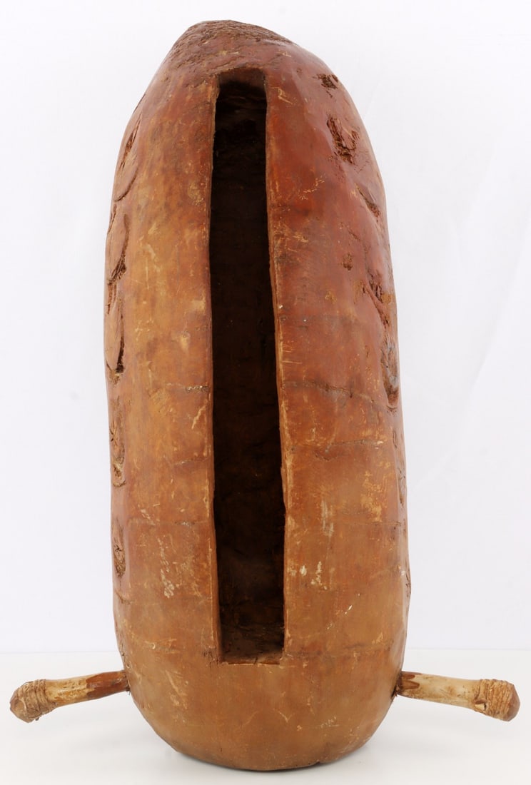 AFRICAN CONGOLESE TALKING DRUM: A talking drum, likely of Congolese origin and early 20th or late 19th century. 24 X 10 X 8 inches. In very good, original condition.