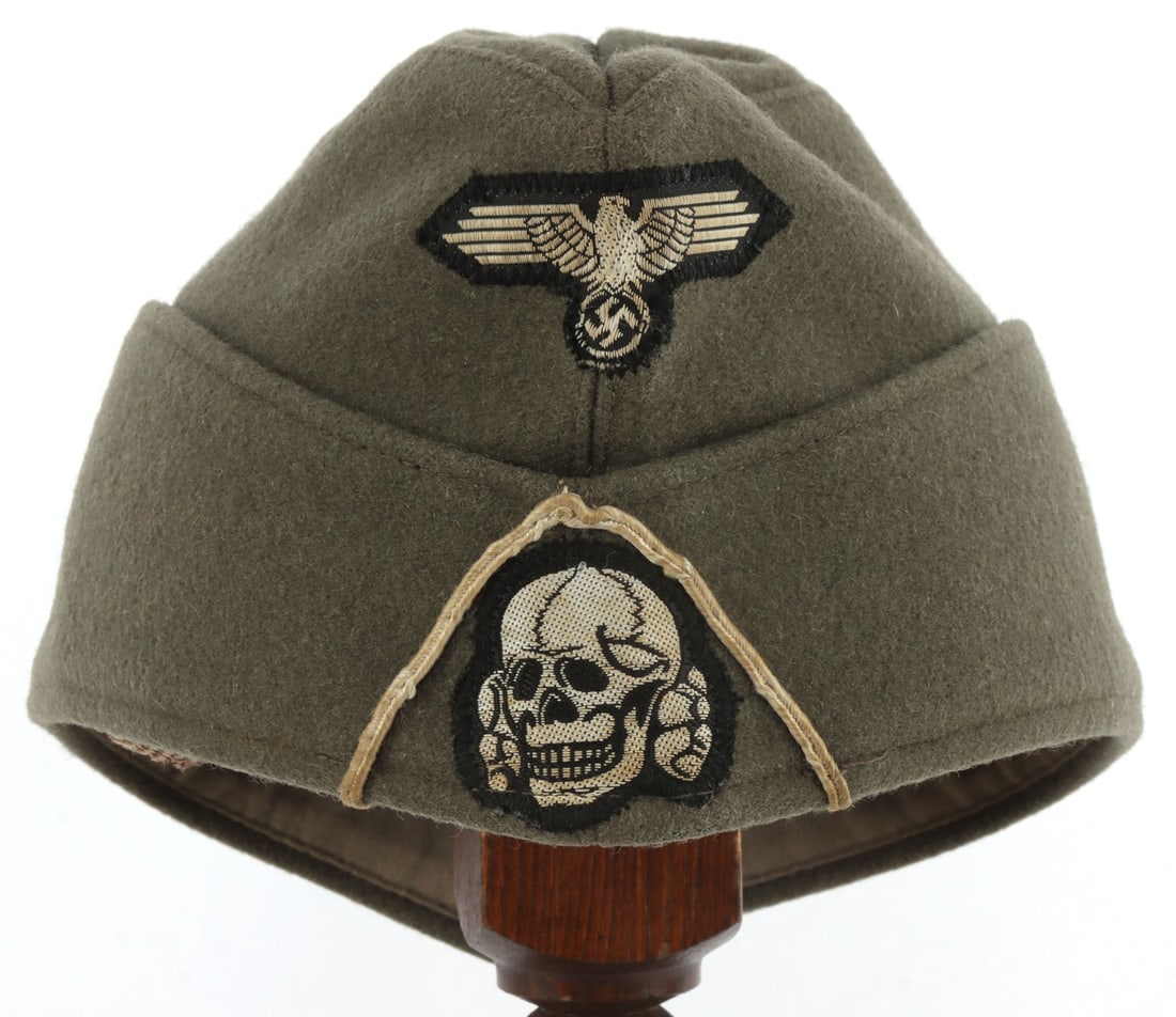 WWII GERMAN THIRD REICH WAFFEN-SS SIDE CAP: Side cap for the Waffen-SS. Totenkopf and Reichsadler on front. Stamped with G. A. Hoffmann Berlin S.W. 29 1943. Size 59. Reichsadler and Totenkopf fluoresce. Unauthenticated, sold "as is."