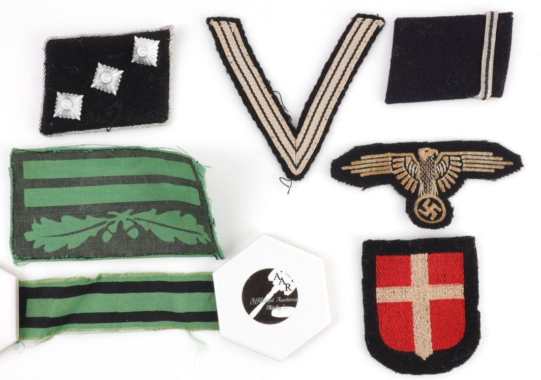 7 PC WWII GERMAN SS INSIGNIA & COLLAR TAB LOT: Lot of SEVEN (7) pieces includes collar tabs, sleeve eagle, volunteer's sleeve shield, camouflage rank insignia, and rank chevron. Fabrics do not fluoresce under UV light. All in good overall conditio
