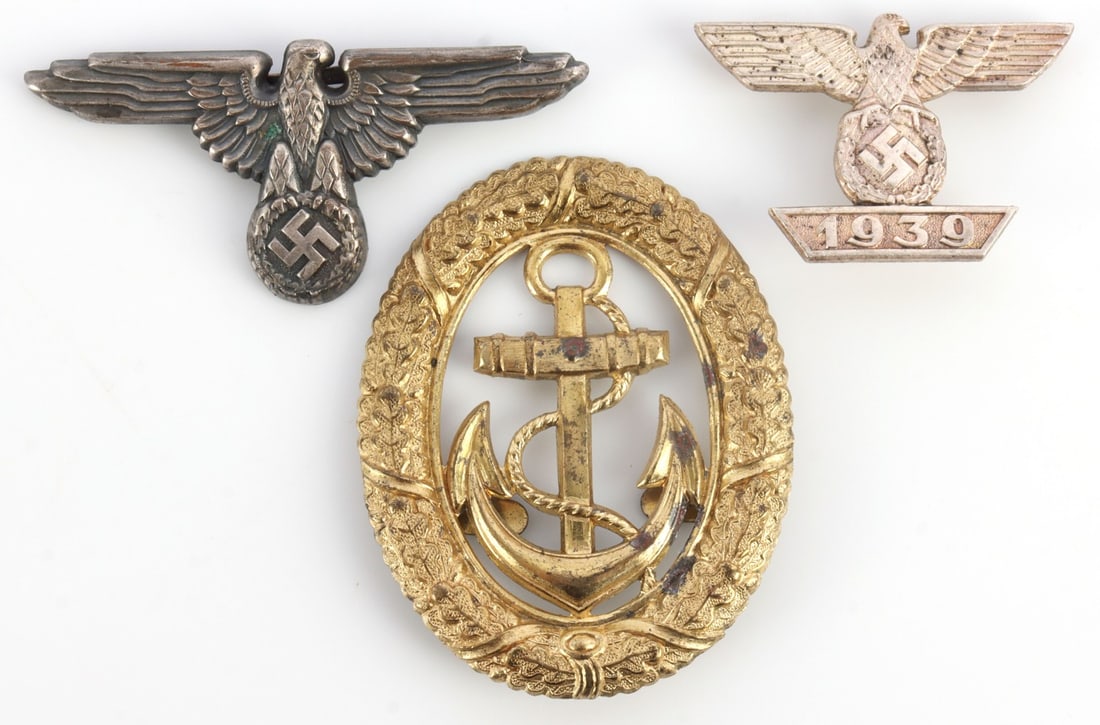 LOT OF 3 WWII GERMAN THIRD REICH INSIGNIA & BADGES: Lot of THREE (3) pieces. Includes SS eagle insignia with vertical pinback marked "L21" (width 1.8 inches), prong-back visor eagle marked "M1/52 RZM" (width 2.68 inches) and Kriegsmarine watch officer 