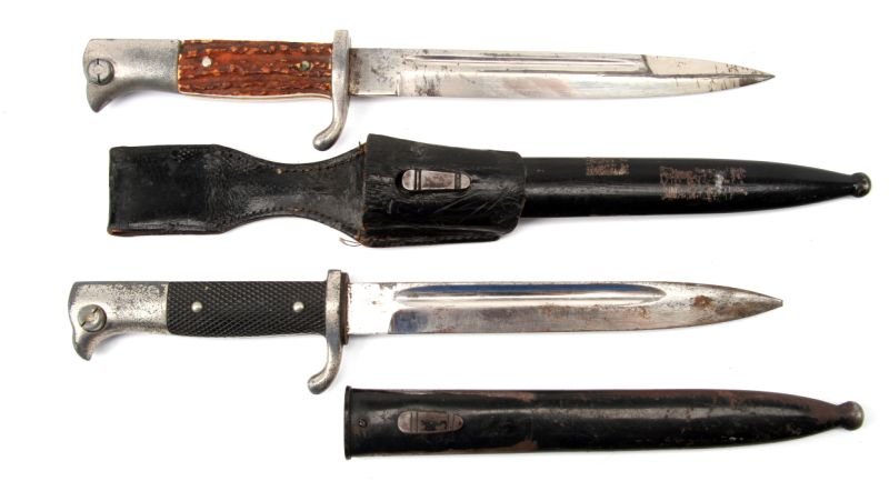 2 WWII GERMAN DRESS BAYONETS KREBS & UNMARKED: Lot of two WWII German dress bayonets. One bayonet, with scabbard and frog, Julius Krebs logo of Lobster in shield on ricasso, and stag horn grips. Second bayonet with standard grips, and prancing lio