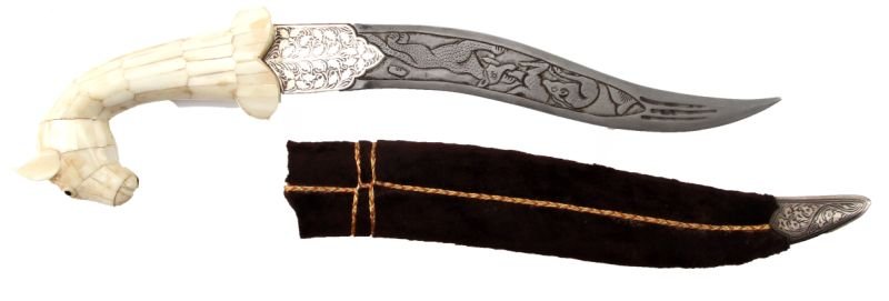 INDIAN-STYLE NIELLO & ENGRAVED KNIFE: 11 inch blade engraved with tigers attacking prey, niello ricasso, and a pieced-bone horse head grip and pommel. Scabbard is brown velvet with a silver niello chape. Overall in very good condition.