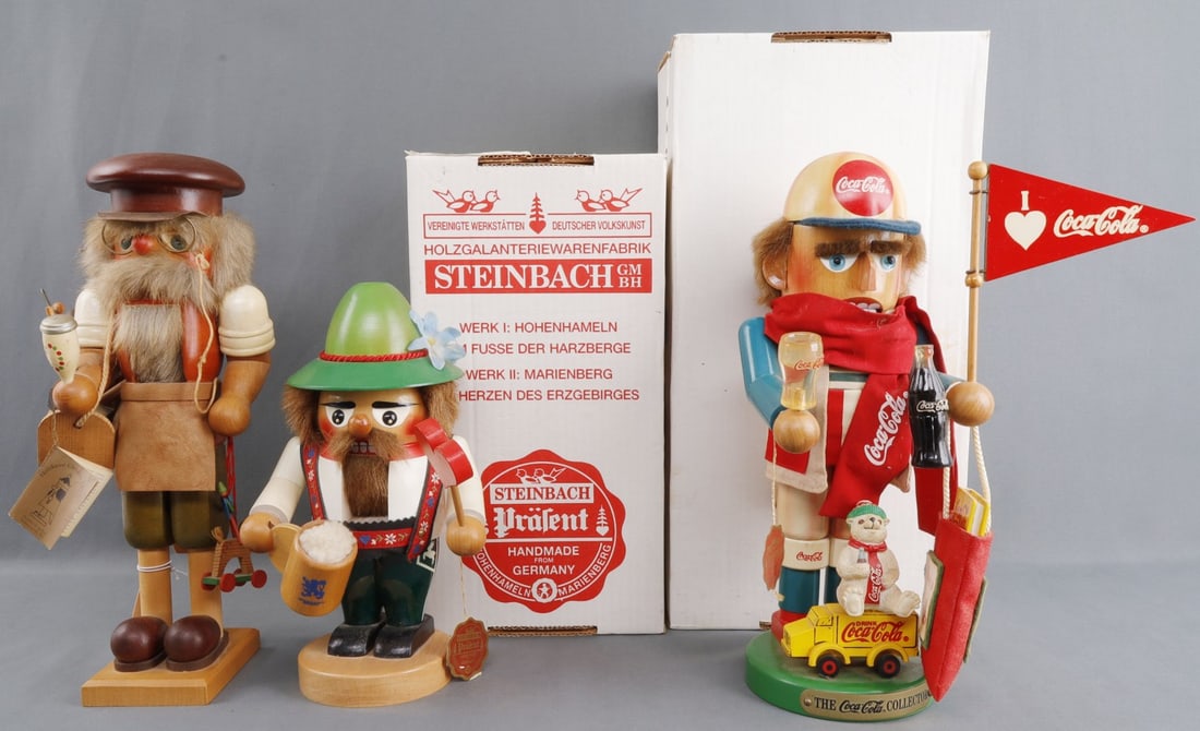 3 HANDMADE GERMAN NUTCRACKERS ULBRICHT & STEINBACH: Lot of THREE (3) nutcracker wood figurines handcrafted in Germany. Includes Christian Ulbricht "Toymaker" (height 13.5 inches), Steinbach "Troll" (height 9.75 inches) and Steinbach "Coca Cola Fan" (he