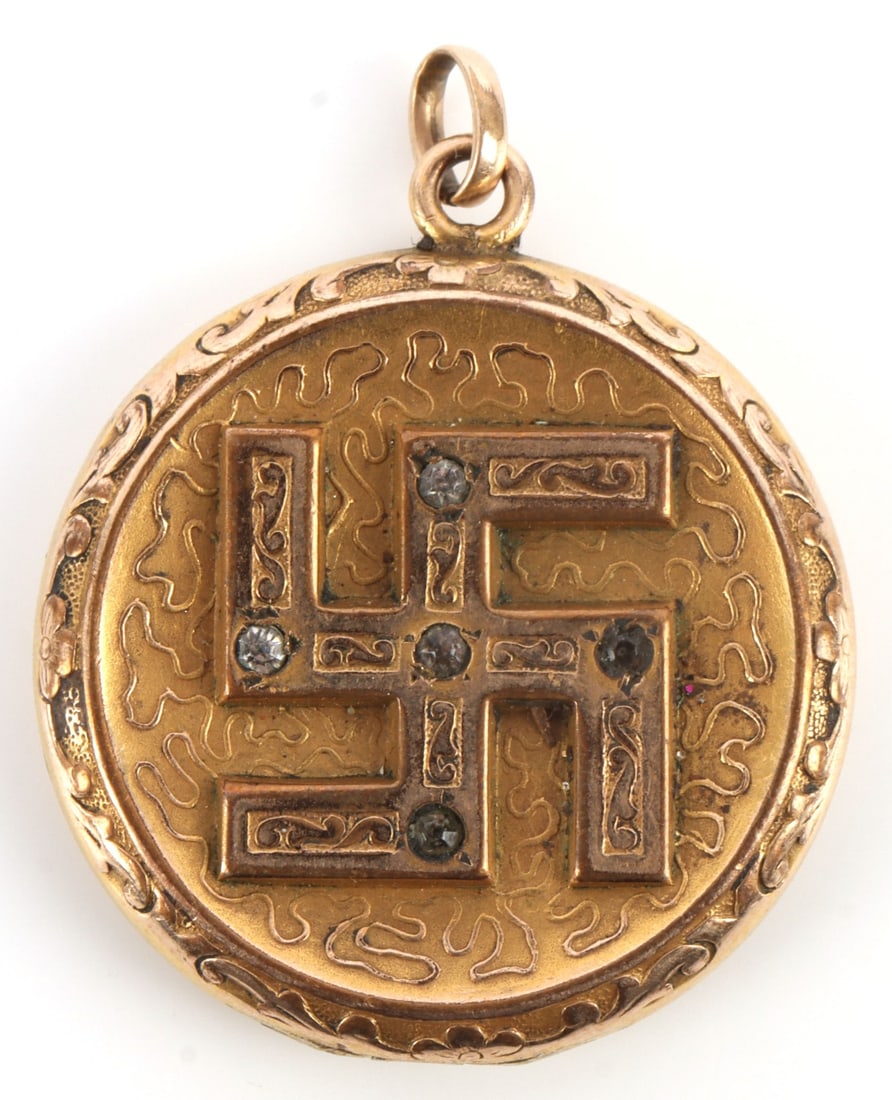 ANTIQUE GOLD FILL W&SB GOOD LUCK SWASTIKA LOCKET: Gold fill sweetheart locket, ca. 1910. Obverse has good luck swastika inset with four rhinestones. Diameter 1.5 inches. Maker's mark "W. & S.B." Very good condition.