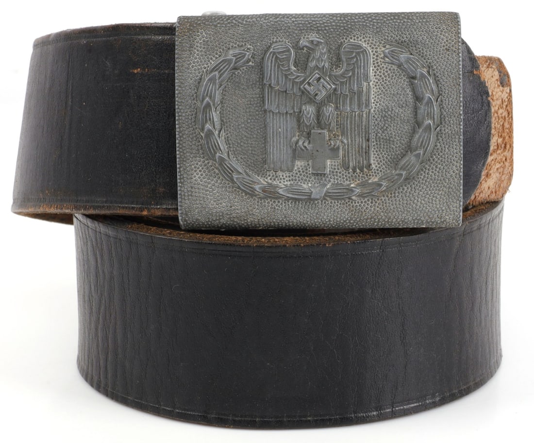 WWII GERMAN THIRD REICH RED CROSS BELT & BUCKLE: Red Cross enlisted man's belt and buckle during the Third Reich. 1) Buckle shows a Reichsadler with a cross on dimpled metal. 2.75 X 2 inches. 2) Belt is black leather and 36 inches long. Very good, o