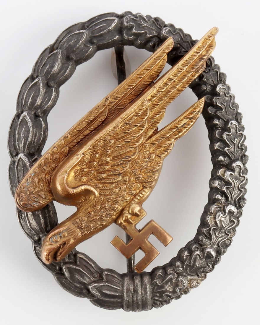 LUFTWAFFE PARATROOPER BADGE WWII GERMAN REICH: Mid-war zinc type with C.E Juncker maker mark. 2 inches. Very good overall condition. This lot has a reserve.