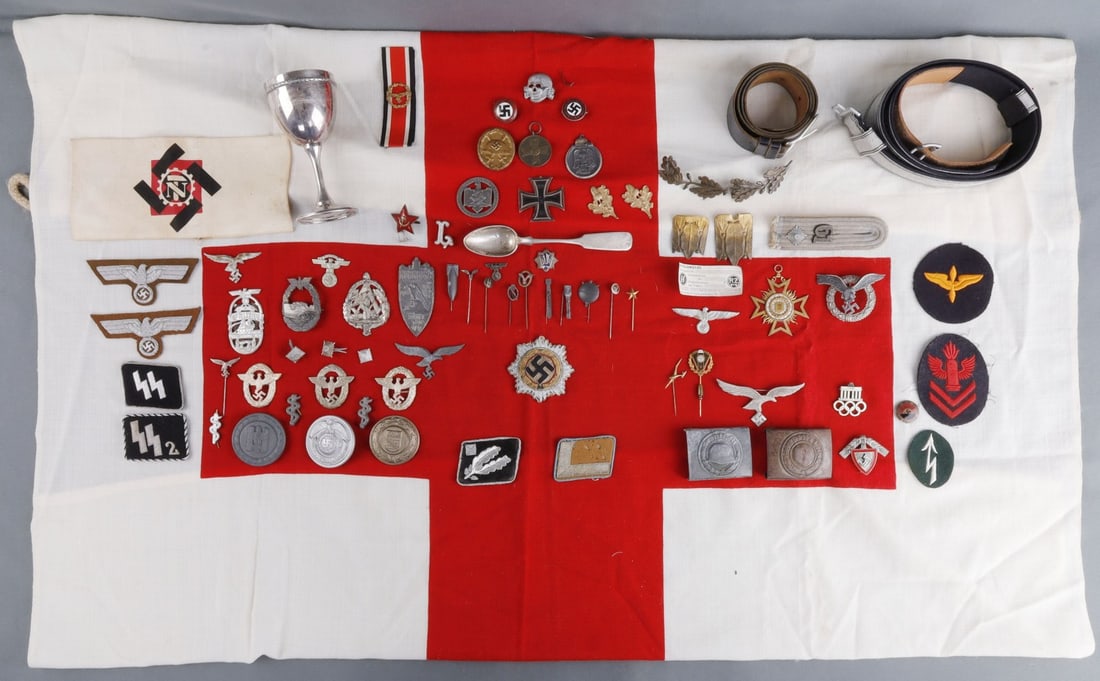 WWII GERMAN MIXED PIN ARMBAND BADGE BELT LOT: Assorted WWII German Third Reich lot. Includes 44 pins, 4 shoulder patches, 1 epaulette, 11 badges, 1 medal, 6 patches, 2 buckles, 1 armband, 1 spoon, 2 belts, 1 red cross flag, and 1 sterling silver 