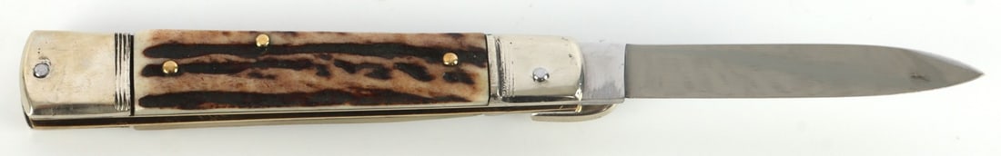 HUBERTUS SPRINGER LEVERLOCK KNIFE: Steel blade with stag grip plates and nickel bolsters. 7.75 inches. This lot has a reserve.