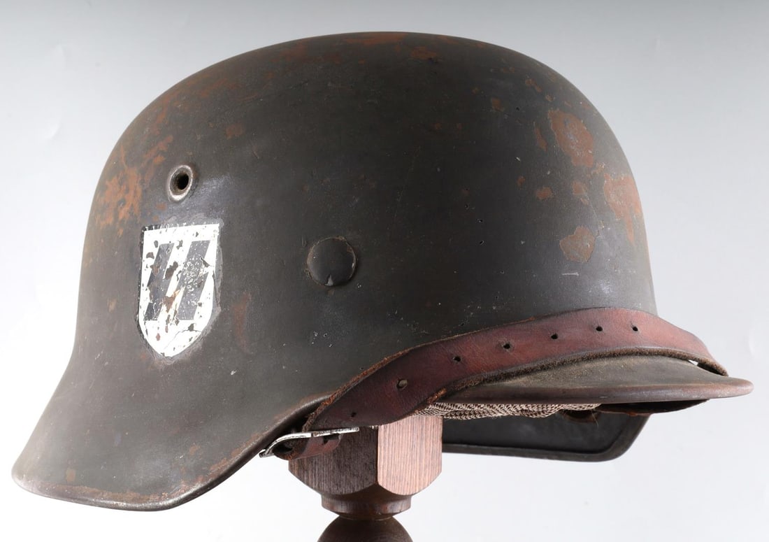 WWII GERMAN THIRD REICH SS SINGLE D M40 HELMET: Some paint loss external, good chinstrap and 8 finger liner, Rear stamped 796, no stampings on either ear.