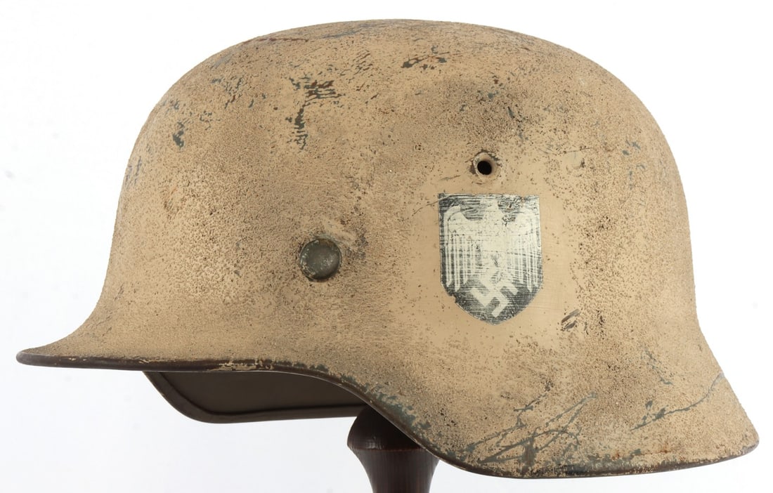 WWII GERMAN WINTER CAMO M40 HELMET: Single decal helmet, winter camo painted. Interior marked ET64 and 1242. Liner is marked 1940 FWM. No leather liner. Very good overall condition. Slight play in rear liner rivet. This lot has a reserv