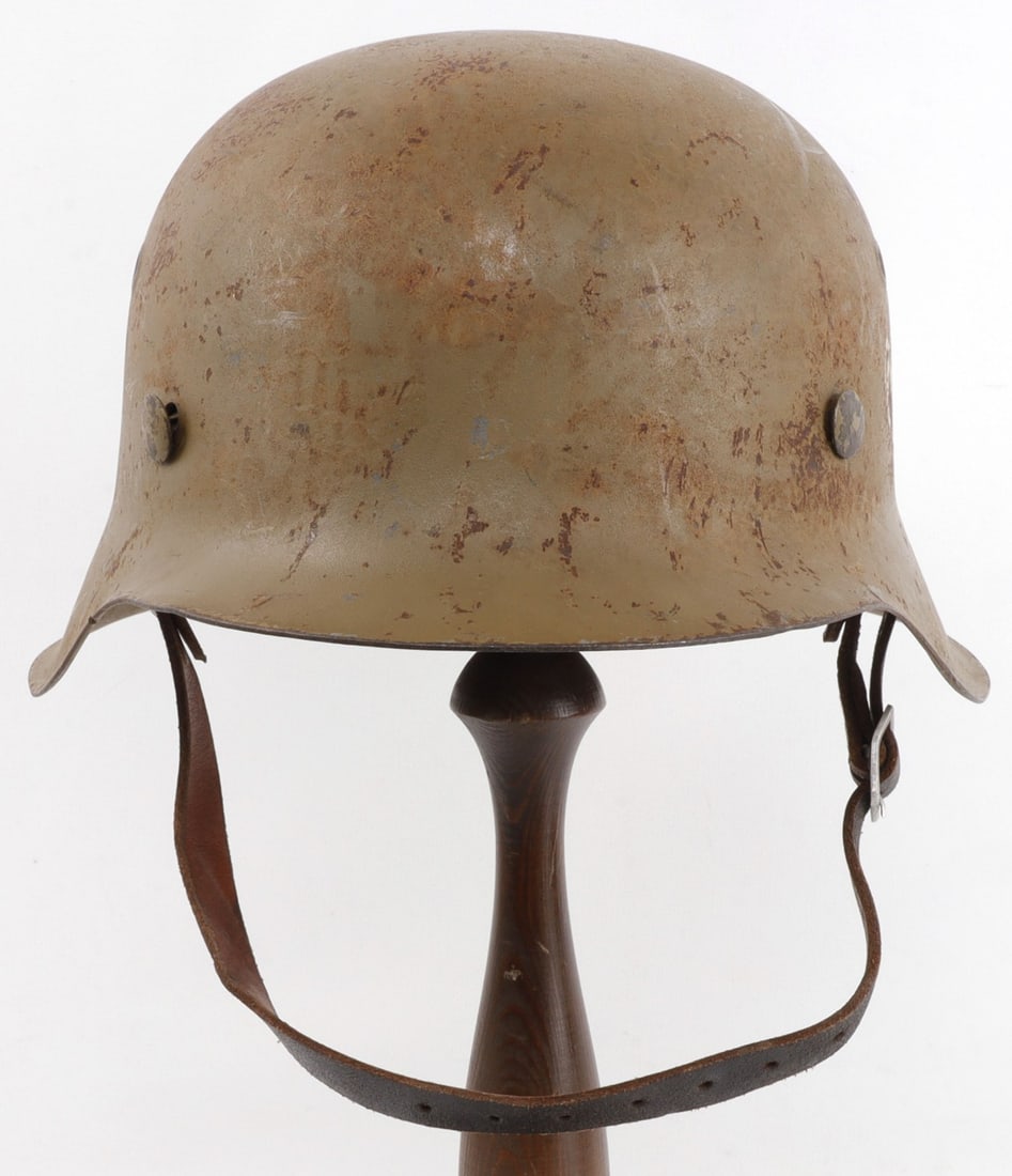 WWII GERMAN DESERT AFRIKA KORPS M42 HELMET: Painted decal and camo painted. Interior marked 3230. Cannot move liner as it is heavily oxidized. Complete with leather liner and chin strap. Very good condition overall. Interior diameter measures 7