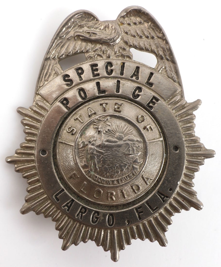 LARGO FLORIDA SPECIAL POLICE BADGE RUSSELL UNIFORM: 2-inch police wallet badge. Marked by maker, "Russell Uniform Co."