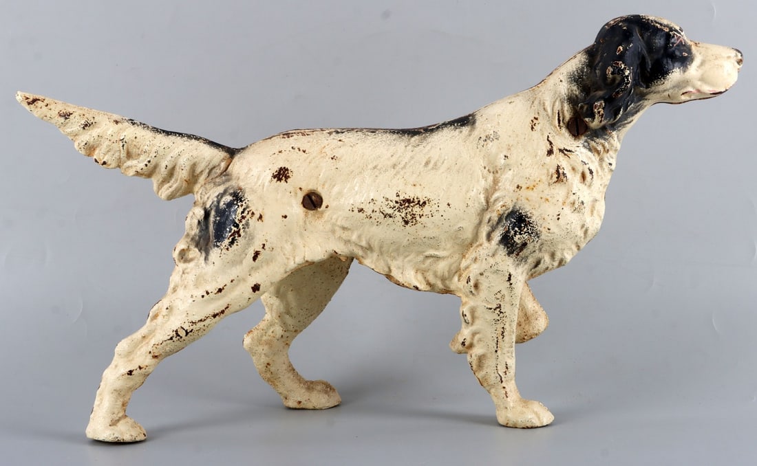 CAST IRON ENGLISH POINTER DOG DOORSTOP HUBLEY: Cast iron English pointer dog doorstop, from Hubley. Early twentieth century. A large amount of the original paint remains. 15 X 8.5 X 3 inches. Very good, original condition.