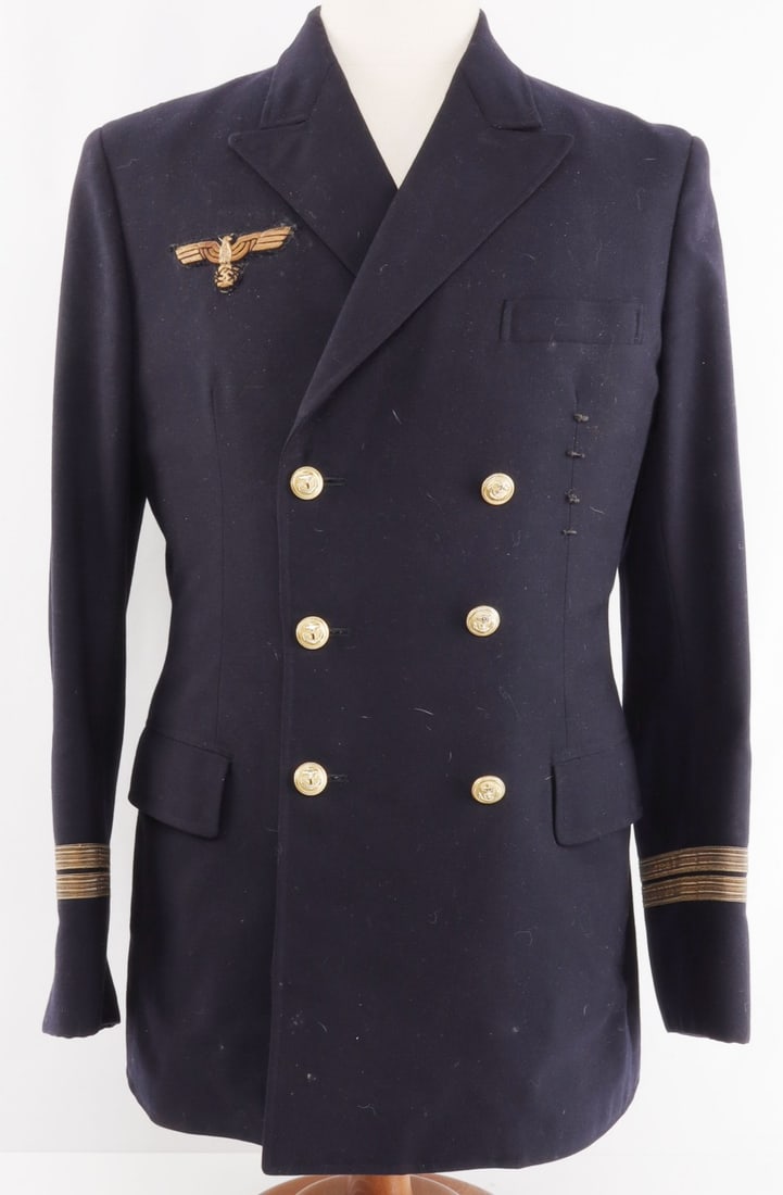 WWII GERMAN THIRD REICH KRIEGSMARINE JACKET: Black jacket for the Third Reich Kriegsmarine. Six brass buttons with anchors on front, marked Overhoff. Kriegsmarine Reichsadler made out of gold bullion, fluorescing. Interior stitching of jacket on