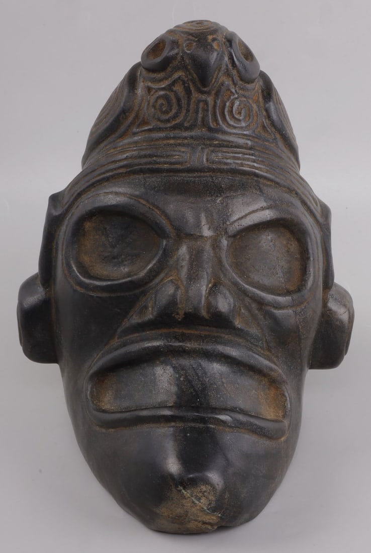 TAINO LARGE ANTHROPIC ZEMI ARTIFACT: Taino large and massive anthropic Zemi with full bodied bird cone. Very bold relief carving. The bird wings are richly engraved with symbolic icons. The head band terminated into duck head ear ornamen