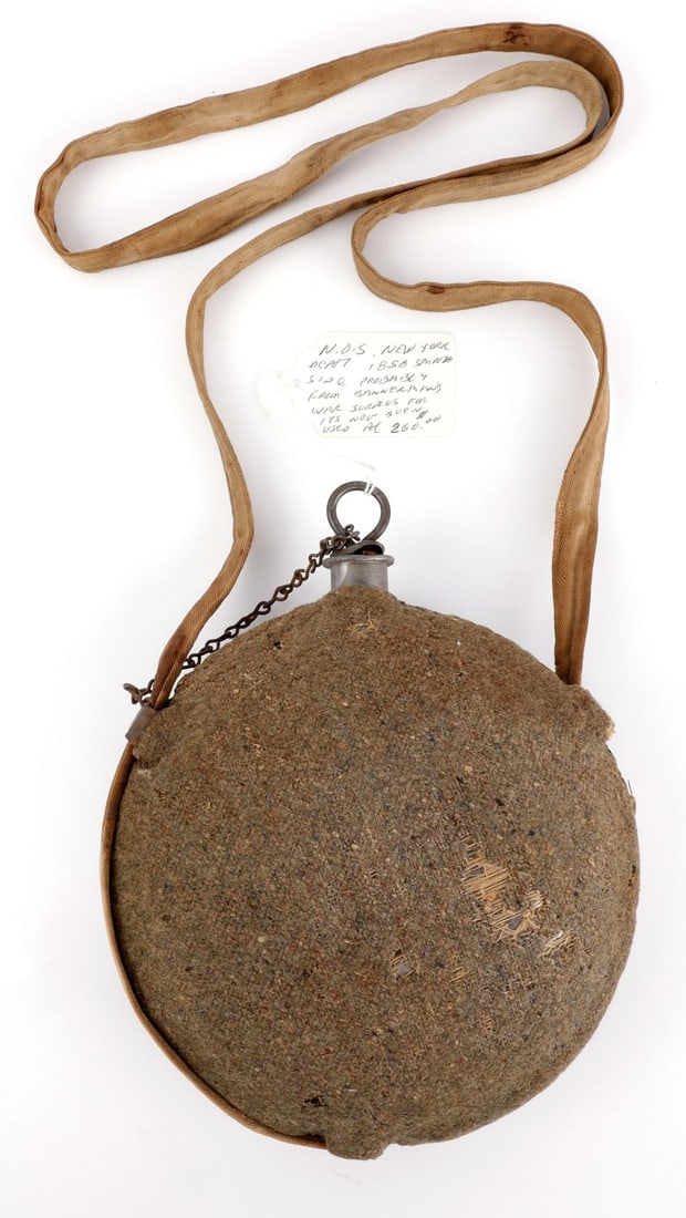 US CIVIL WAR MODEL 1858 SMOOTH SIDE CANTEEN CLOTH: Smooth side canteen with a wool cloth cover. White fabric strap remains intact. Cork plug is broken from cap, but intact on hook. Some mothing present. 8-inch diameter. Very good, original condition.