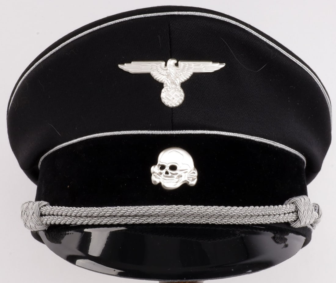 WWII GERMAN THIRD REICH SS OFFICER VISOR: Post war piece. Standard black visor with totenkopf and eagle Headband diameter measures 7 3/4 inches.