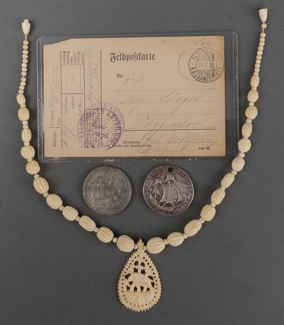SMALL DEALERS LOT OF ANTIQUES NECKLACE COIN LETTER: Lot of FOUR (4) small items. 1) Bone necklace featuring carving of an elephant. 2) Hudson's Bay replica coin, partially silver. 3) American Revolutionary War replica coin. 4) German letter from the 1s