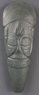 PRECOLUMBIAN TAINO CARVED CELT AXE HEAD: Pre-Columbian Taino (1000-1500 CE) carved ceremonial axe head, commonly known as a celt. This celt is carved with an incredibly abstract figure, possibly depicting either a standing, smiling figure