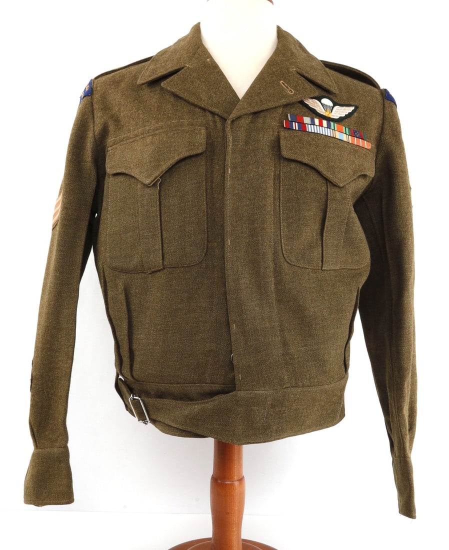 WWII CANADIAN PARATROOPER NCO BATTLE DRESS TUNIC: Commonwealth battle dress tunic of olive green wool. Left breast has embroidered parachute wings and two rows of ribbon bars for WWII service in France & Germany, Canadian Forces' Decoration and Korea