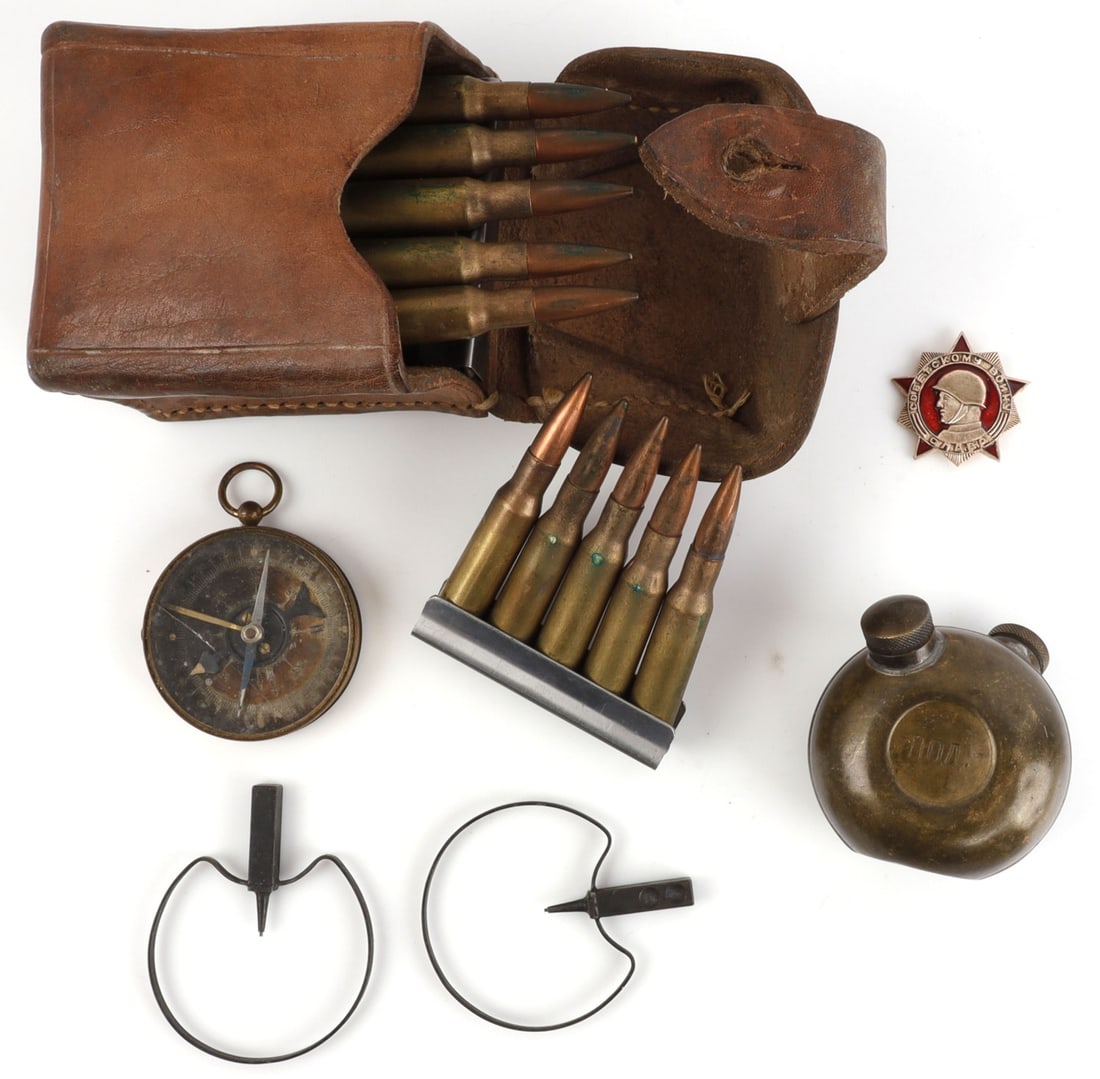 LOT OF 10 MOSIN NAGANT CARTRIDGE POUCH & RELICS: Lot of TEN (10) pieces. Includes leather Mosin-Nagant cartridge pouch containing four (4) five-round clips (7.62x54r cartridges headstamped "88"), pair of shrouded gunsights, Russian double oiler, Fre