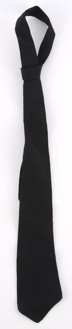 WWII GERMAN THIRD REICH BLACK SS NECKTIE: 3 (W) X 45.5 (L) inches. Has a machine embroidered bevo woven cotton tag on the reverse side that reads ?Vom Reichsfuhrer SS befohsene Ausfuhrung SS RZM?. Machine sewn black cotton construction. Unaut