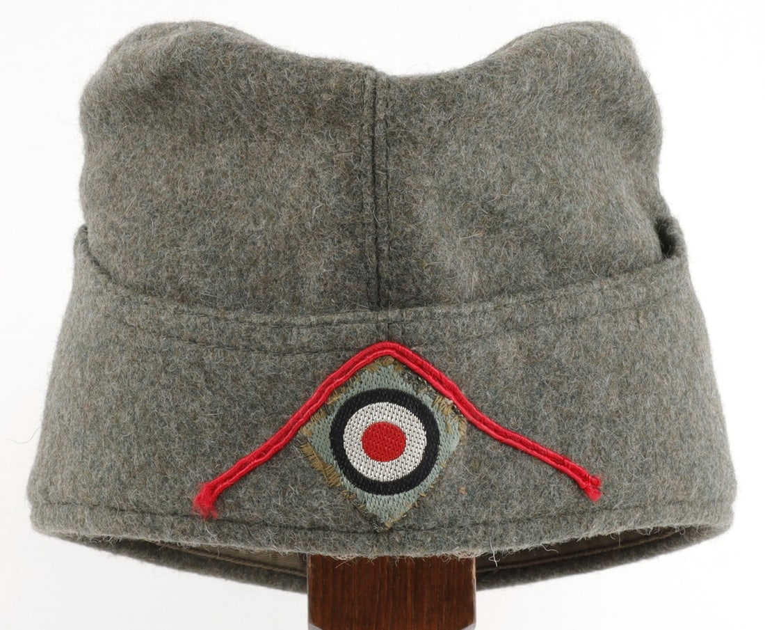 WWII GERMAN HEER ARTILLERY OVERSEAS CAP: Field grey wool with red stripe and cockade. No stamps on interior. 11 inches. Very good condition.
