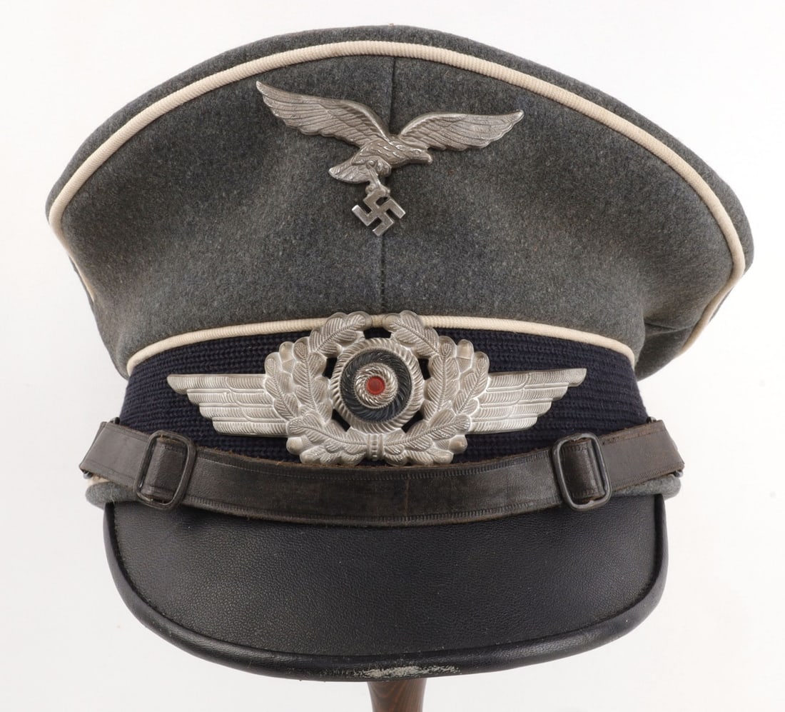 WWII GERMAN LUFTWAFFE GORING PANZER DIVISION VISOR: Exterior and interior of visor in very good original condition. Liner completely intact. Tailor's tag reads "Beste Qualitat" & "57." Nametag inside visor reads "G. Hoffman Fsch/Pz. Div. 1 HG."